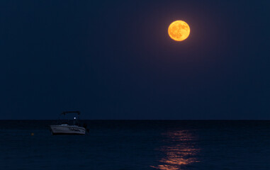 Nighttime boat trip under full moon