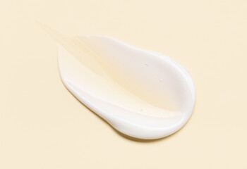 Close-up of cosmetic cream smear, smooth and shiny texture, pastel background