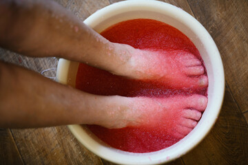 Relaxing foot spa treatment with pink gel.