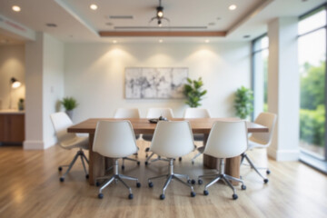 Blurred background of a contemporary conference room showcases a large table surrounded by white chairs, designed for collaboration and creativity with ample natural light and modern aesthetics.