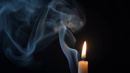 A flickering candle illuminates the darkness as beautiful white smoke gracefully rises and swirls against a deep black background creating a serene and mystical ambiance - Powered by Adobe