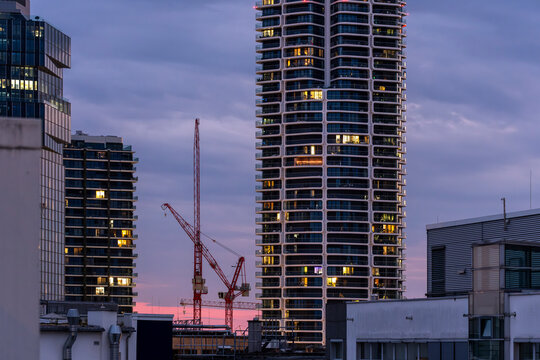 Sunset cityscape featuring construction crane and skyscraper urban architecture tower development for finance business growth