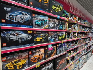 Fototapeta premium Dnipro, Ukraine 11.13.2025: Lego cars. Various LEGO construction sets and kits are displayed on shelves at a toy store. This demonstrates the brand's popularity and presence in retail.