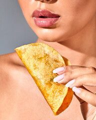 Young woman holding corn tortilla tacos. Mexican food concept