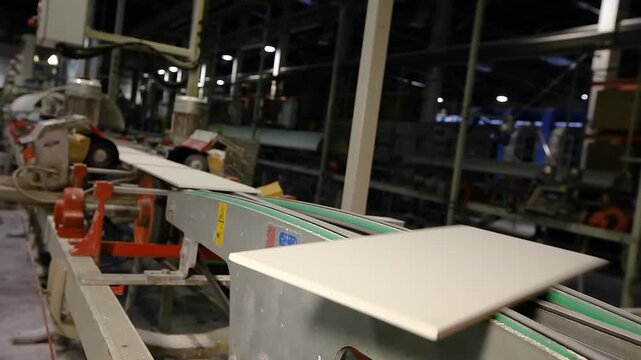 Ceramic tiles and porcelain tile factory. Ceramic tile manufacturing plant. The process of making ceramic tiles. Conveyer line for ceramic tile at plant.