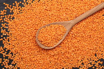 Red lentils on a wooden spoon 