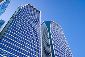 Futuristic glass skyscrapers against a blue sky in the Tel Aviv business district, Israel. Contemporary architecture in the Middle East.