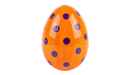 Isolated orange Easter egg with purple polka dots for spring holiday celebration theme.
