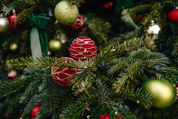 Natural fir branches decorated with festive red gold Christmas balls, New Year magic decor and details
