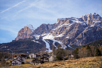 Aerial view of snow-capped mountains towering over the quaint village nestled in the valley of Tofane, Cortina d'Ampezzo, Veneto, Italy.