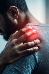 Man Experiencing Discomfort in Shoulder While Grasping Muscles