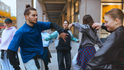Street dancers showcasing layered outfits during casual rehearsal. Concept of streetwear promotion,...