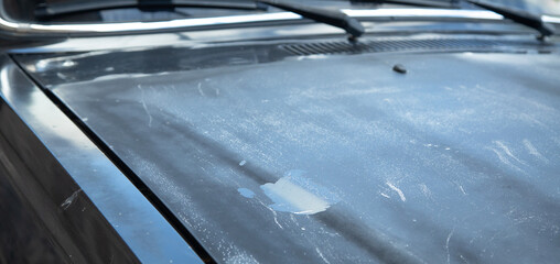 Old car with damaged paint. Close up view