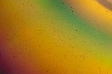 Abstract vintage-style background featuring textured grain, dust, scratches, and soft colorful light effects. Aged analog aesthetics create a dynamic, distressed atmosphere suitable for cinematic and 