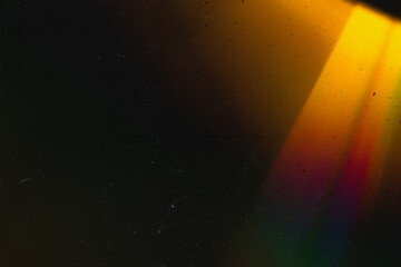 Abstract vintage-style background featuring textured grain, dust, scratches, and soft colorful light effects. Aged analog aesthetics create a dynamic, distressed atmosphere suitable for cinematic and 