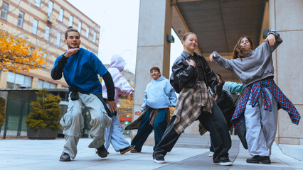 Hip hop dancers rehearsing routine together in urban location. Concept of youth oriented brand...