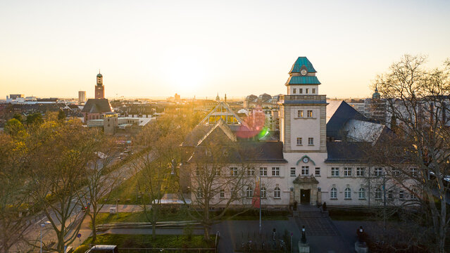 Aerial view of the Jugendstilbad Darmstadt, where the warm glow of the sunset illuminates the building's architecture, Darmstadt, Hessen, Germany.