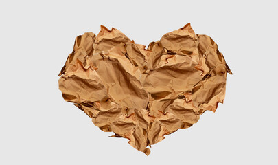 Heart made of paper scraps, isolated. Sustainable Valentine's Day concept, sustainability love. Modern abstract image. Crumpled used paper, sepia tones. Minimalist paper wallpaper