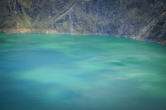 View of the mesmerizing turquoise waters of the Quilotoa lake, edged by rugged cliffs under the Ecuadorian sun, Quilotoa lake, Cotopaxi province, Ecuador.
