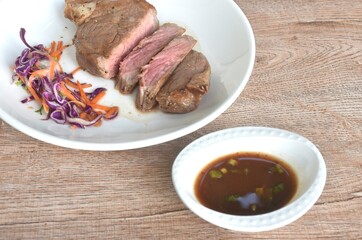 grilled pepper Picanha beef steak and chop vegetable salad on plate dipping spicy sauce 