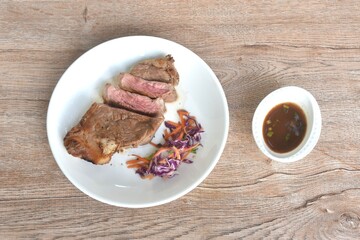 grilled pepper Picanha beef steak and chop vegetable salad on plate dipping spicy sauce 