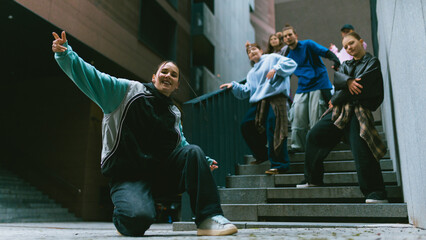 Hip hop dancers expressing individuality on city stairs. Concept of youth self expression, brand communication, social media content, lifestyle advertising, fashion promotion, authentic urban culture.