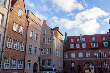 Poland. The Cow Gate in the city of Gdansk. Buildings frame an archway connecting to a bridge.