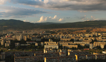 Panoramic Tbilisi city in Georgia landscape in sunset, from high angle view