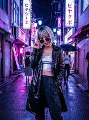 A stylish woman with short hair and sunglasses poses confidently in a wet alley, illuminated by the purple neon signs of a Japanese city at night.