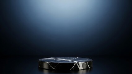 Dark blue spotlight illuminating a black marble pedestal in a studio setting