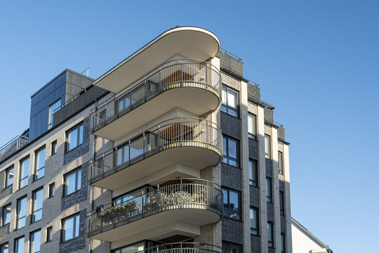 View of modern architecture rises with rounded balconies against the clear blue sky, showcasing the beauty of urban design, Vastra Hamnen, Malmo, Sweden.