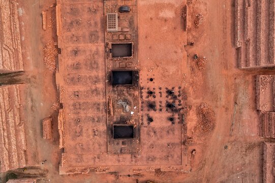 Aerial view of a symmetrically designed building with a monochromatic palette of red-brown hues and geometric patterns, Dhaka, Dhaka Division, Bangladesh.
