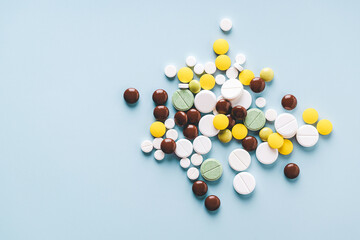 Group of various pills on blue background, top view. Medicine concept