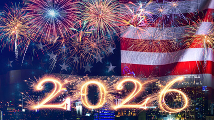 American flag waving with fireworks over city at night. Fireworks display on New Year's Eve to welcome the New Year.