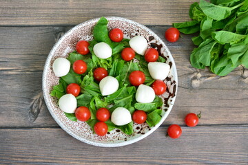 Fresh Caprese Salad with Cherry Tomatoes and Mozzarella and lettuce top view