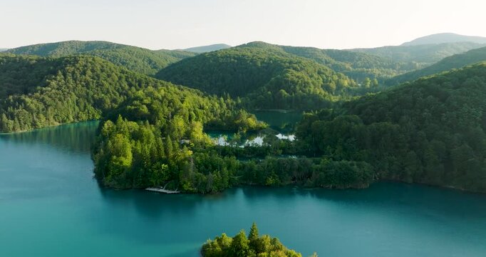 Aerial view of the vibrant turquoise waters intertwining with lush green forests in the Plitvice Lakes National Park, Plitvice, Croatia.