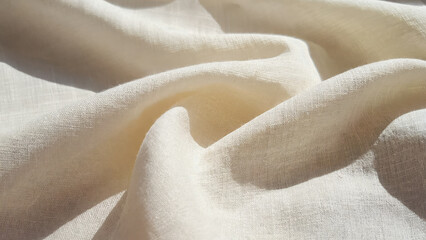 Cloud Dancer warm white linen fabric surface showing elegant gentle folds and soft textured background. Color of the Year 2026. Cloud Dancer