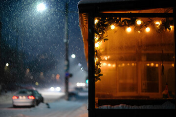 Warm Interior Lighting Reflected on Window Looking Out at Snowy Winter Street