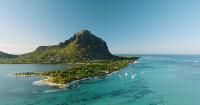 Aerial view of Le Morne Brabant mountain standing tall amidst the turquoise ocean and lush green landscape, Le Morne, Mauritius.