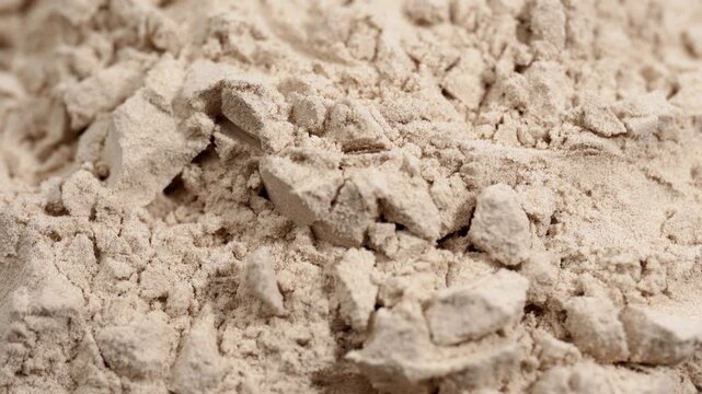 Protein powder in a measuring spoon. Bodybuilding, fitness and lifestyle in the gym. The concept of sports, health and nutrition	
