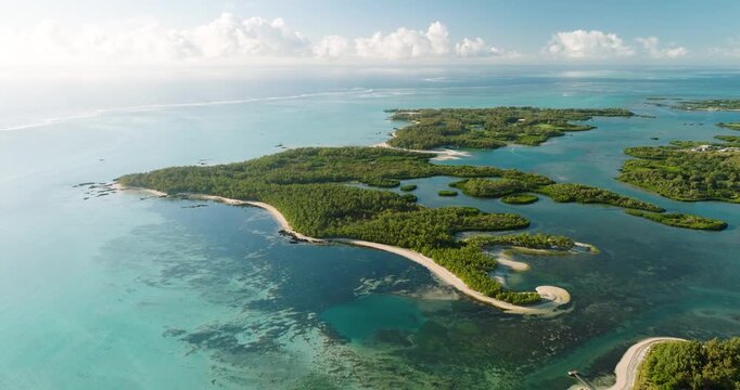 Aerial view of vibrant coastlines and islands with lush green vegetation, contrasting with the turquoise waters of the ocean, Shangri-La, Mauritius.