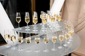 Elegant multi-tier arrangement of champagne flutes filled with sparkling wine