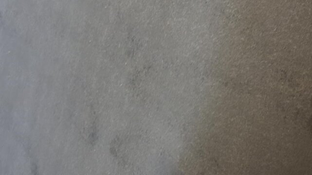Spraying paint coating on textured surface with a spray gun for protection and finishing work