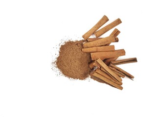 Cinnamon powder and dry cinnamon on white background. Flat lay 