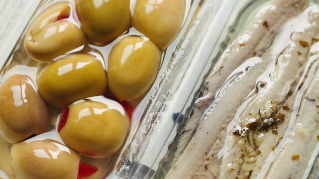Traditional Catalan snacks for wine, beer and vermouth include green olives and anchovies. High quality 4k footage