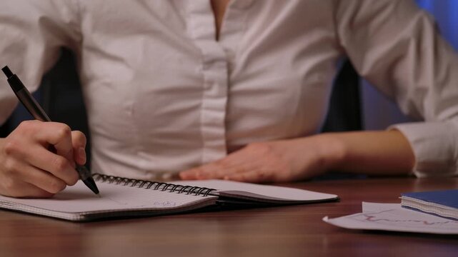 Close up of Woman Writing Notes in Notebook