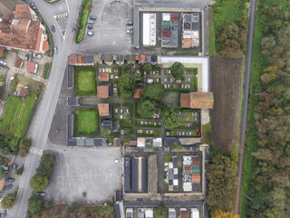 Aerial view of the cemetery's orderly rows of graves and mausoleums creating a somber yet structured tableau, Serino, Irpinia, Italy.