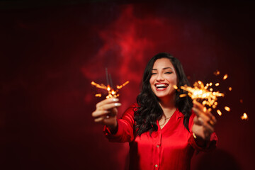  successful business woman celebrating, isolated on red light background with copy space.