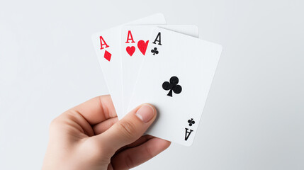 Obraz premium Hand holding three aces playing cards against a clean bright symbolizing luck and winning a game