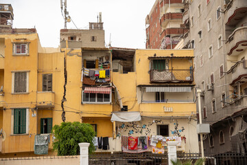 Crack down the center of an apartment building across from the Catacombs of Kos el Shoqafa in Alexandria, Egypt